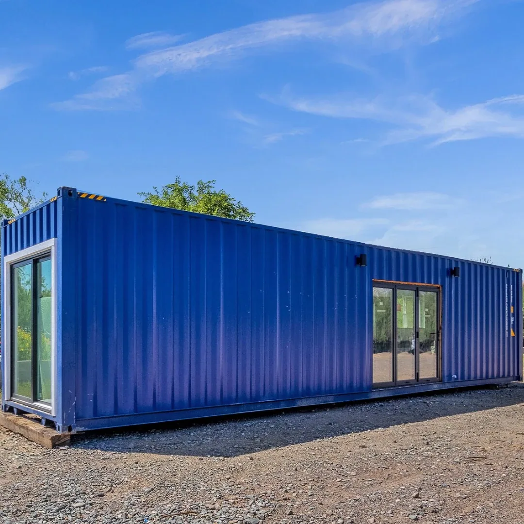 Blue 40 foot shipping container home with sliding glass door and awning, built by Tiny Custom House in Arizona