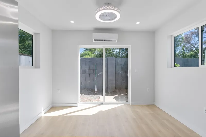 Open living area with the glass slider open onto the patio